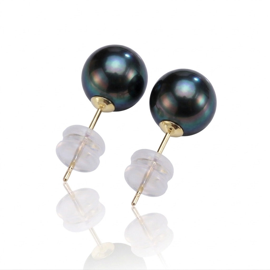 Pair of black pearl earrings with gold and clear stone accents on a white background