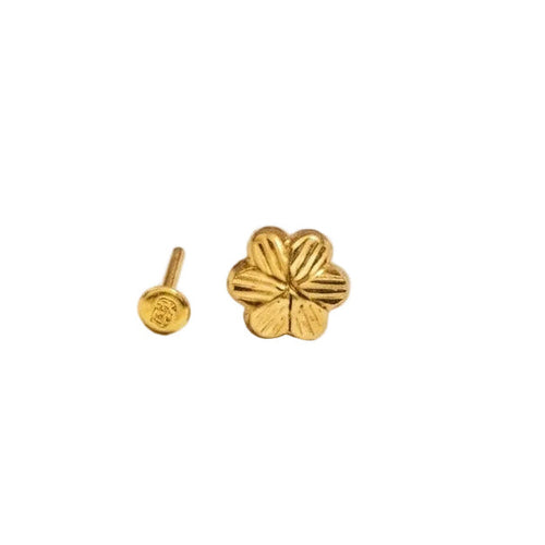 Gold ring with a red gemstone on a white background