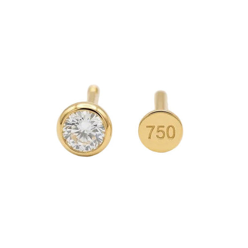 Gold stud earrings with a diamond on a white background