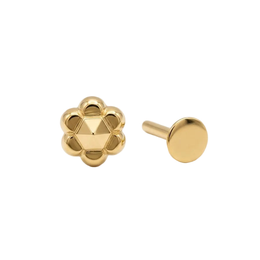 Gold earring with geometric design on a white background