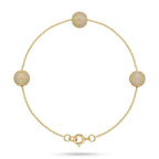 Gold bracelet with spherical beads on a white background