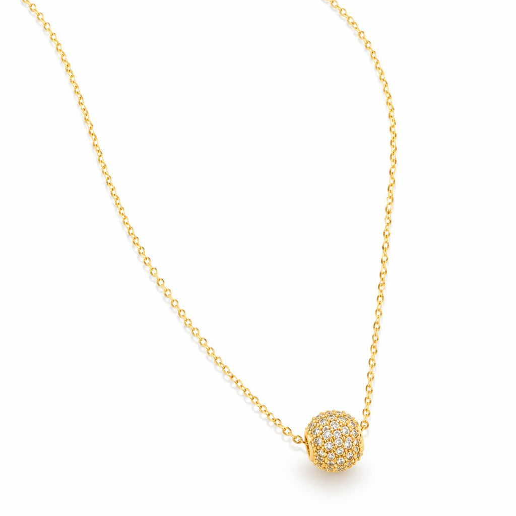 Gold necklace with a round, diamond-studded pendant on a white background