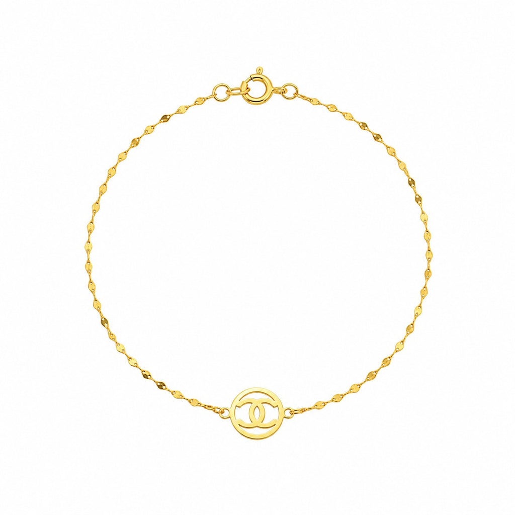 Gold bracelet with a circular design on a white background
