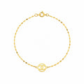 Gold bracelet with a circular design on a white background
