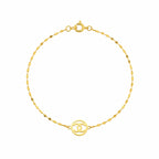 Gold bracelet with a circular design on a white background