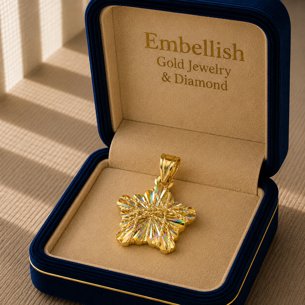 Gold jewelry pendant in a 'Embellish Gold Jewelry & Diamond' box on a wooden surface.