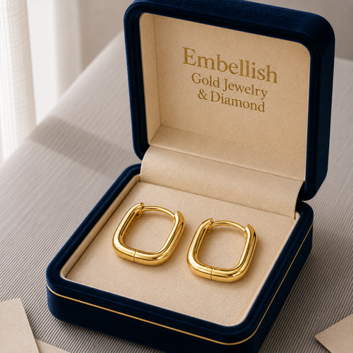 Gold earrings in a 'Embellish Gold Jewelry & Diamond' box on a neutral background
