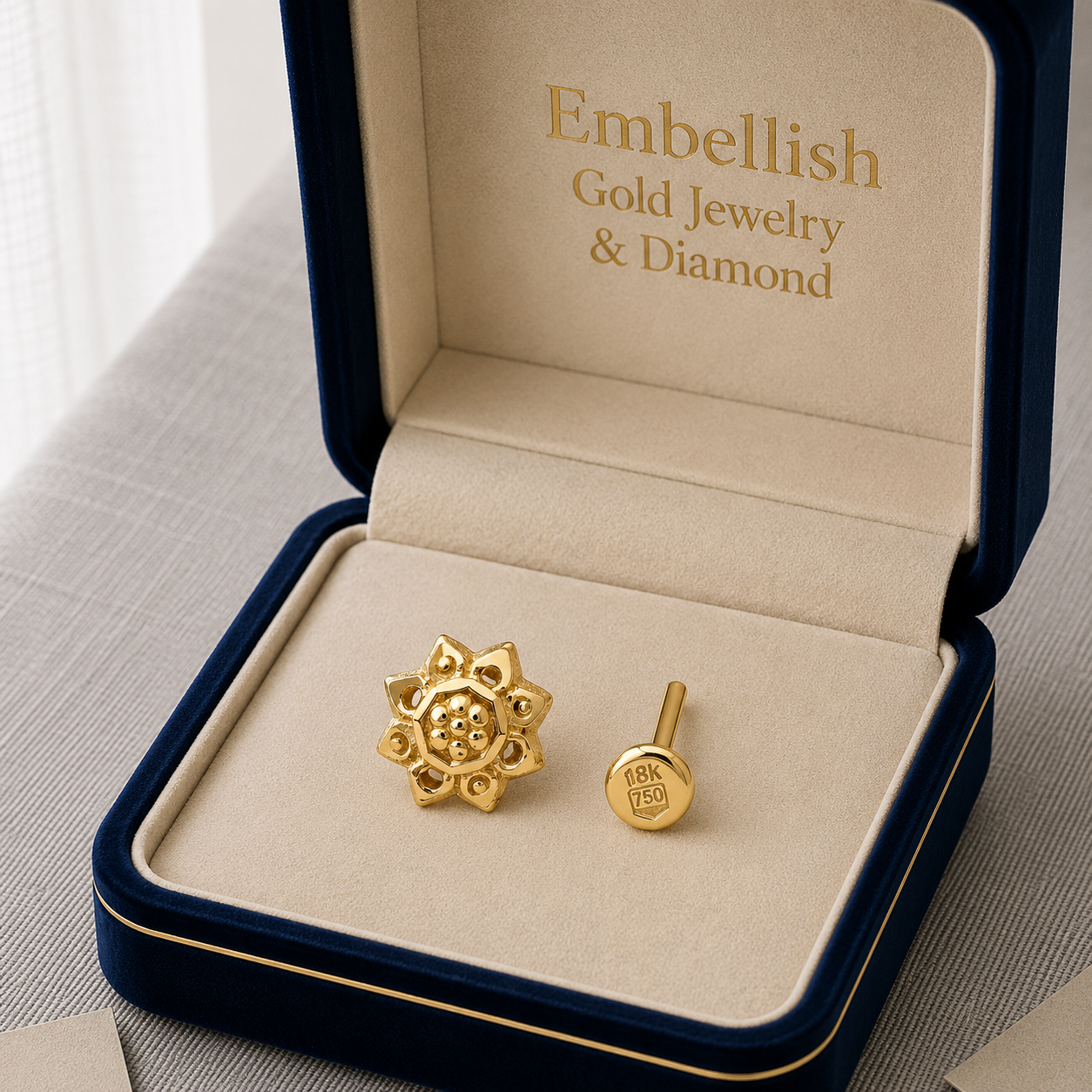 Gold jewelry set in a 'Embellish Gold Jewelry & Diamond' box on a light background