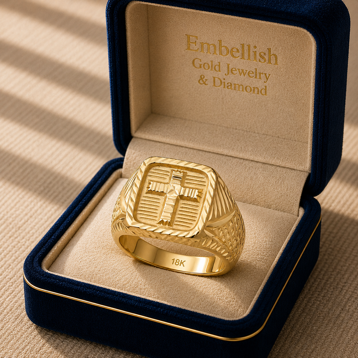 Gold ring with cross design in a 'Embellish Gold Jewelry & Diamond' box.