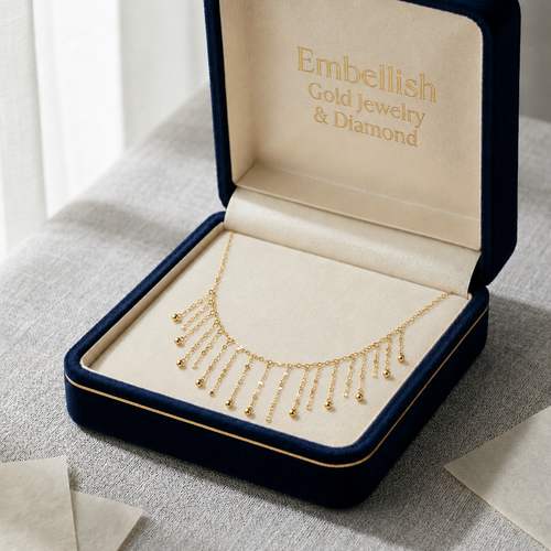 Gold necklace in an open jewelry box with 'Embellish Gold Jewelry & Diamond' branding.
