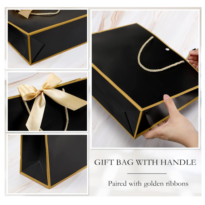 Black gift bag with handle and golden ribbons on a white background