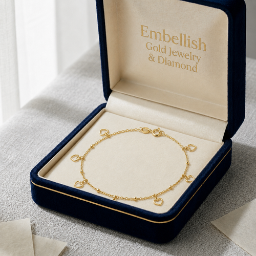 Gold bracelet in an open jewelry box with 'Embellish Gold Jewelry & Diamond' branding.
