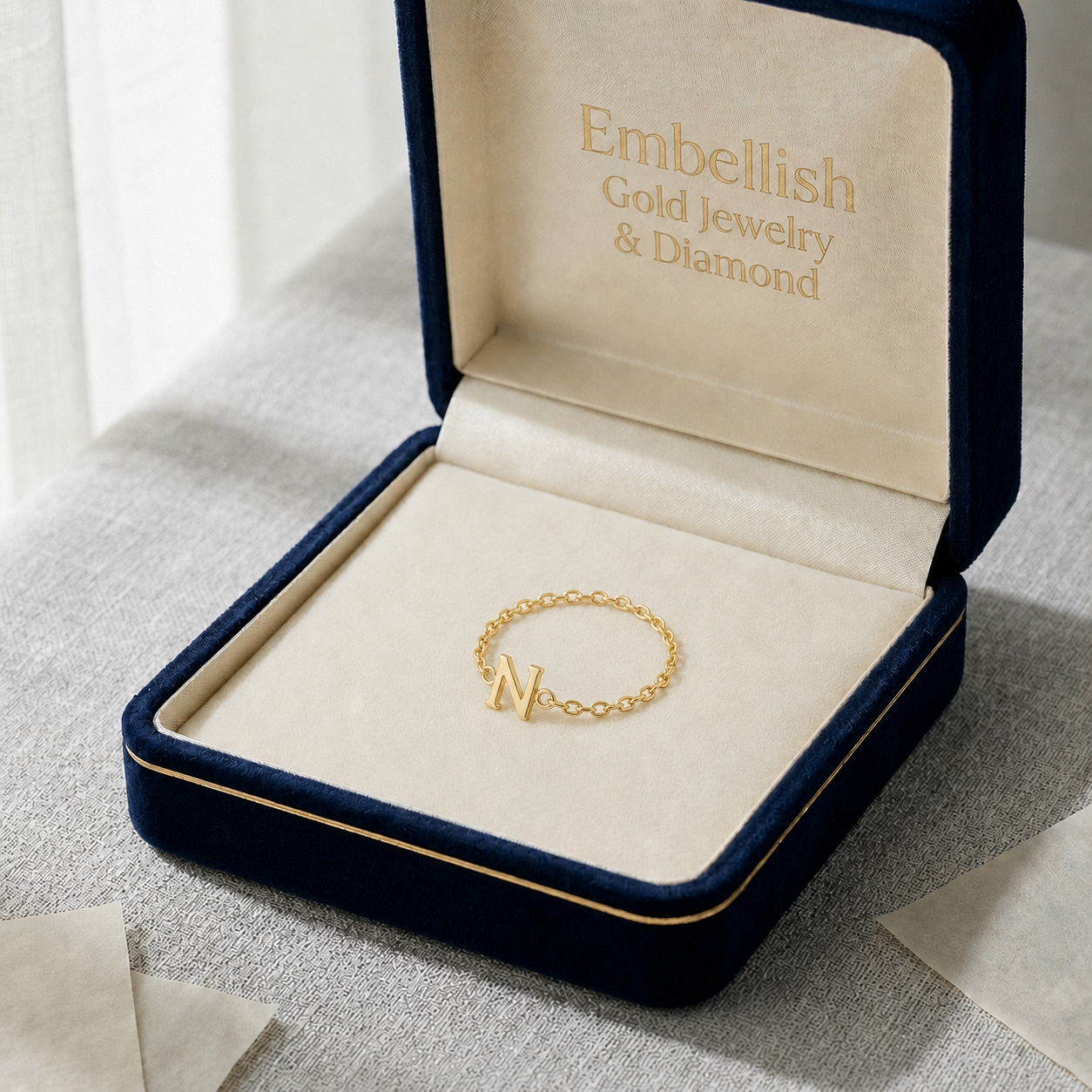 Gold bracelet in a 'Embellish Gold Jewelry & Diamond' box on a light surface.