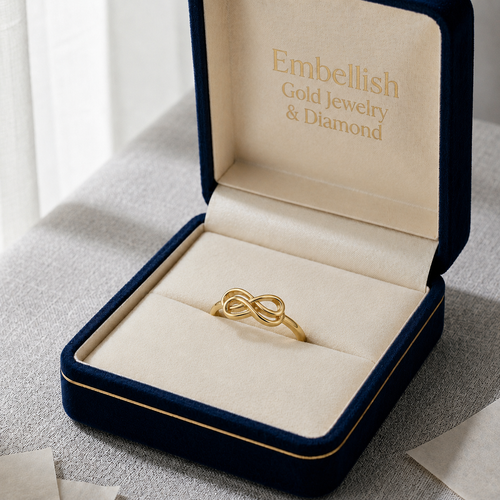 Gold knot ring in an open jewelry box with 'Embellish Gold Jewelry & Diamond' branding.