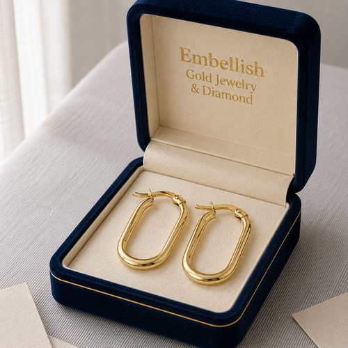 Gold hoop earrings in a 'Embellish Gold Jewelry & Diamond' box on a light surface.
