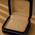 Gold necklace in an open jewelry box with 'Embellish Gold Jewelry & Diamond' branding.