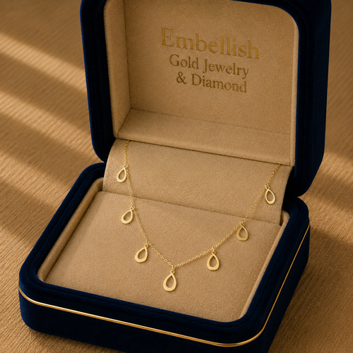 Gold necklace in an open jewelry box with 'Embellish Gold Jewelry & Diamond' branding.