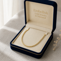 Gold necklace in an open jewelry box with 'Embellish Gold Jewelry & Diamond' branding.