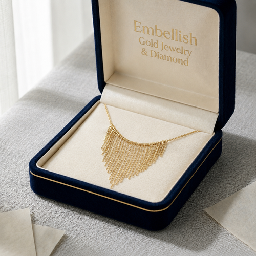 Gold necklace in an open jewelry box with 'Embellish Gold Jewelry & Diamonds' branding.