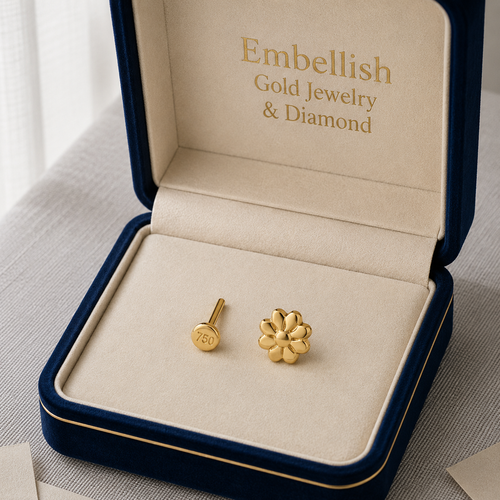 Gold earrings in a 'Embellish Gold Jewelry & Diamond' box on a light background