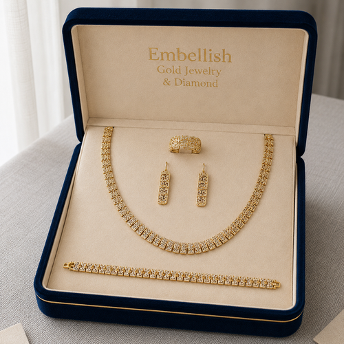 Gold jewelry set including necklace, earrings, and bracelet in an 'Embellish' box.