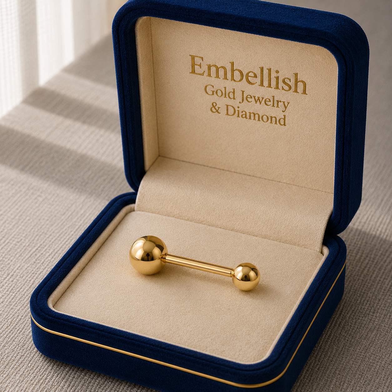 Gold bar earring in a 'Embellish Gold Jewelry & Diamond' box on a textured surface.