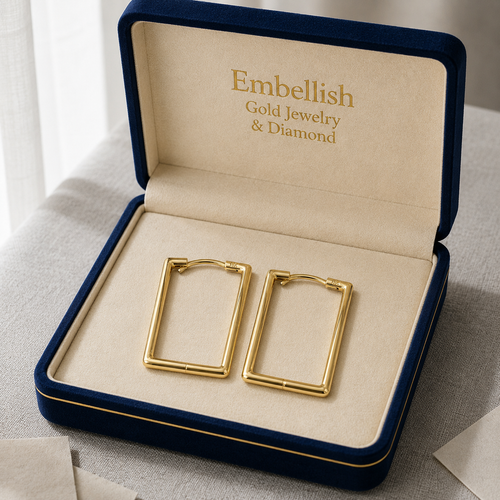 Gold earrings in a 'Embellish Gold Jewelry & Diamond' box on a neutral background